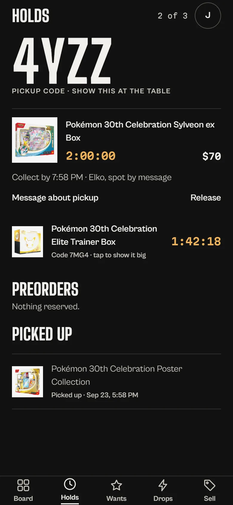 The customer's holds on the Ghost Pulls app: the Sylveon ex Box under pickup code 4YZZ, and the Elite Trainer Box under code 7MG4.